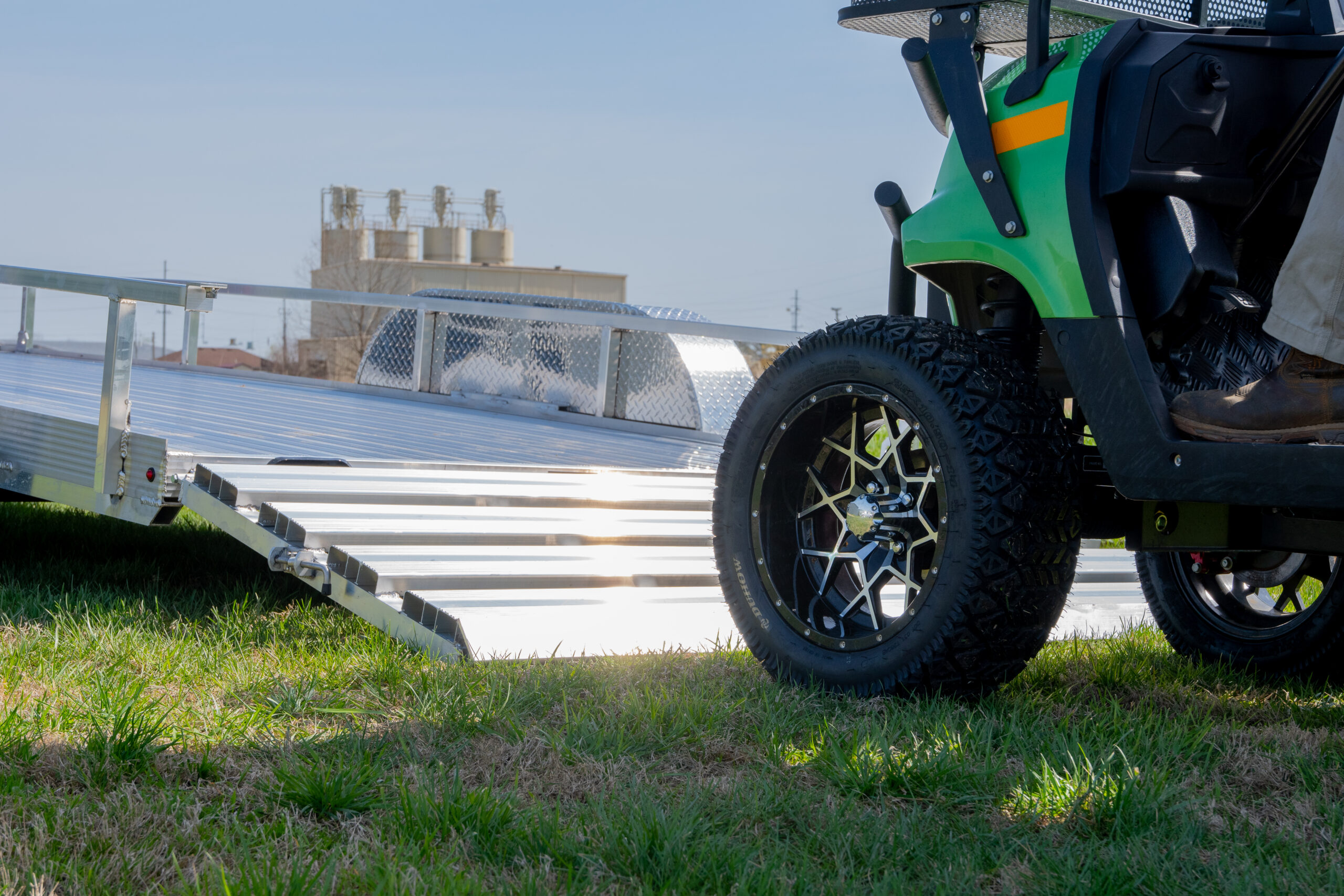 close up of golf cart going on double axle