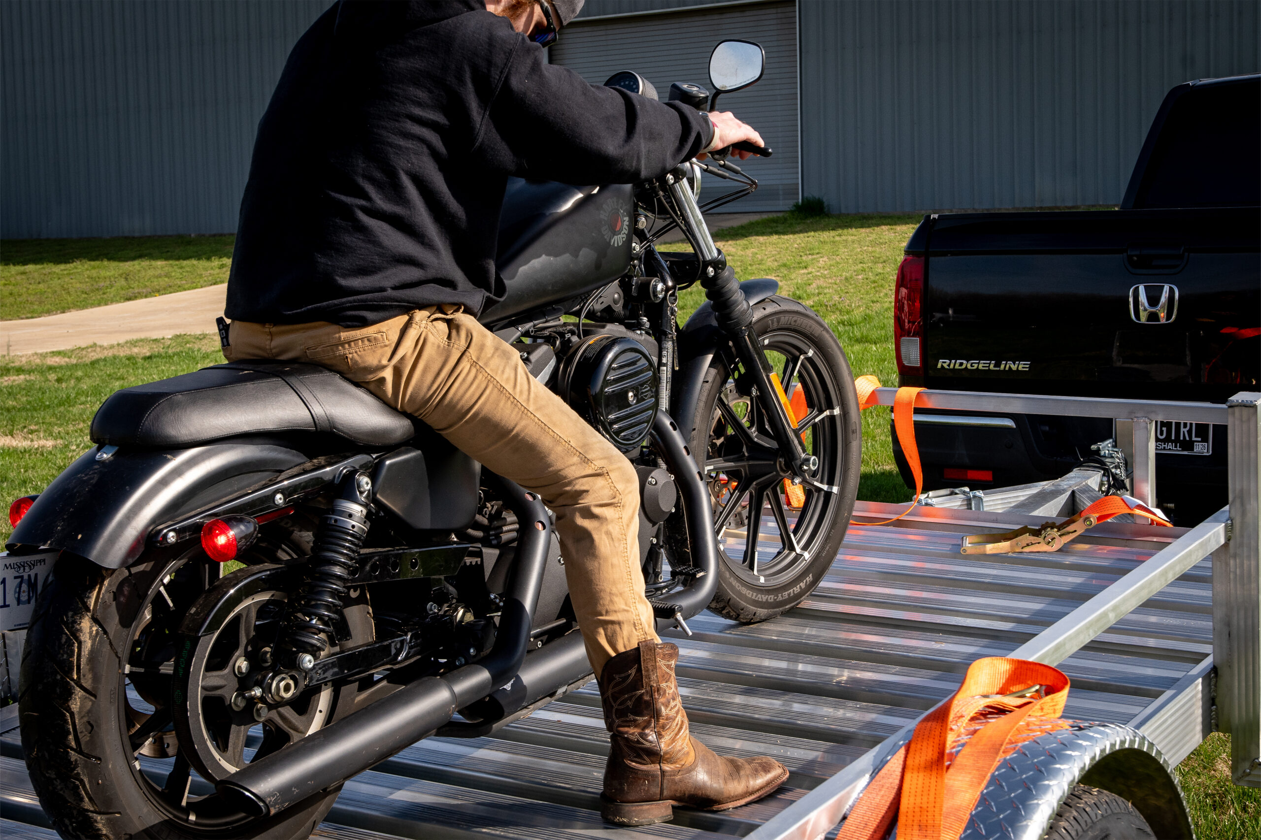 open plank aluminum trailer with motorcycle